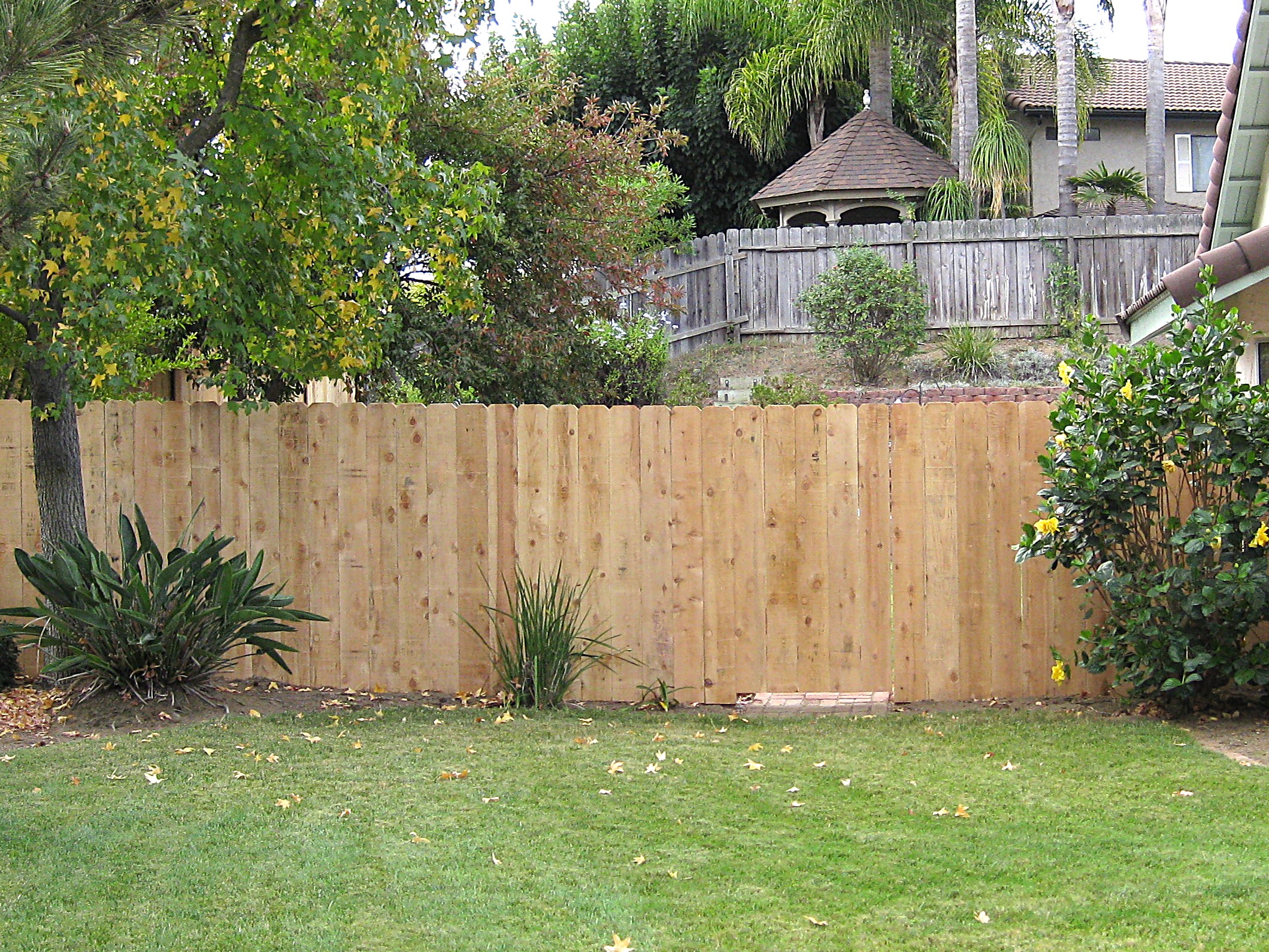 Dog-eared cedar fence by Alpine Fence Company.