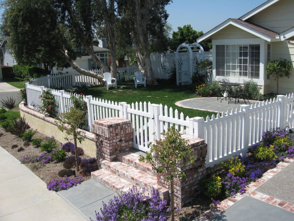 Straight top vinyl picket fence by Alpine Fence Company.