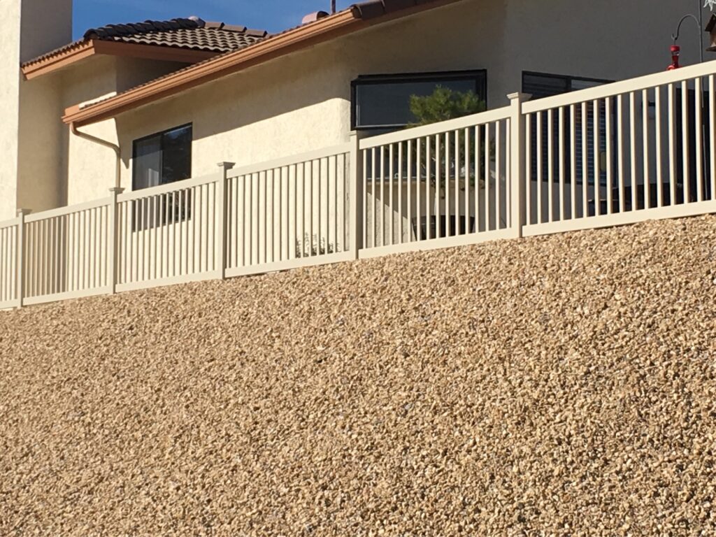 Tan universal vinyl fence by Alpine Fence Company.