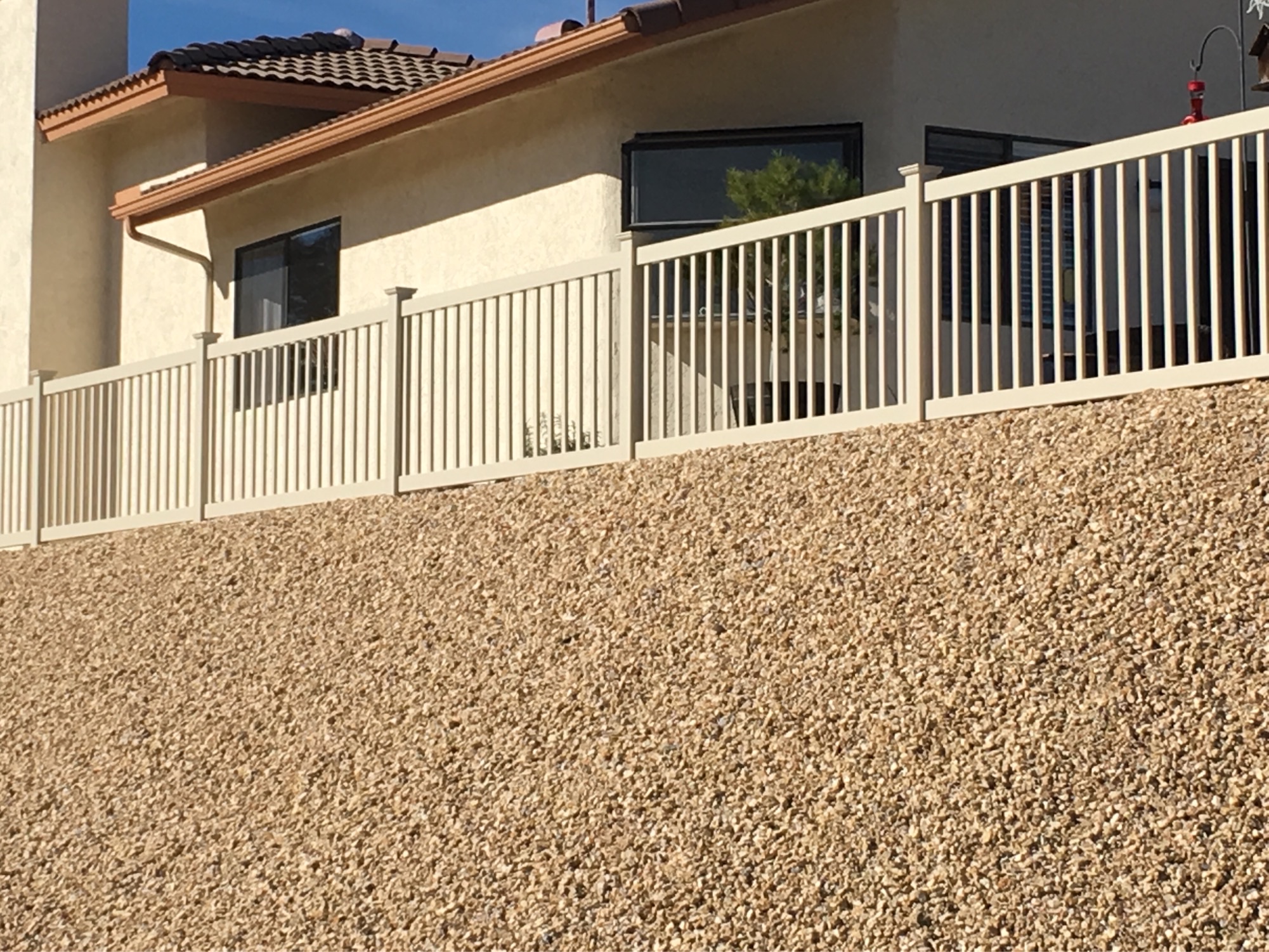 Tan universal vinyl fence by Alpine Fence Company.