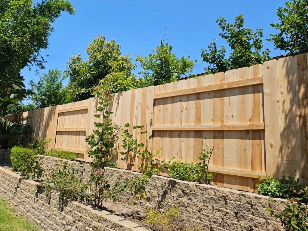 Dog-eared cedar fence with alternating panels by Alpine Fence Company.