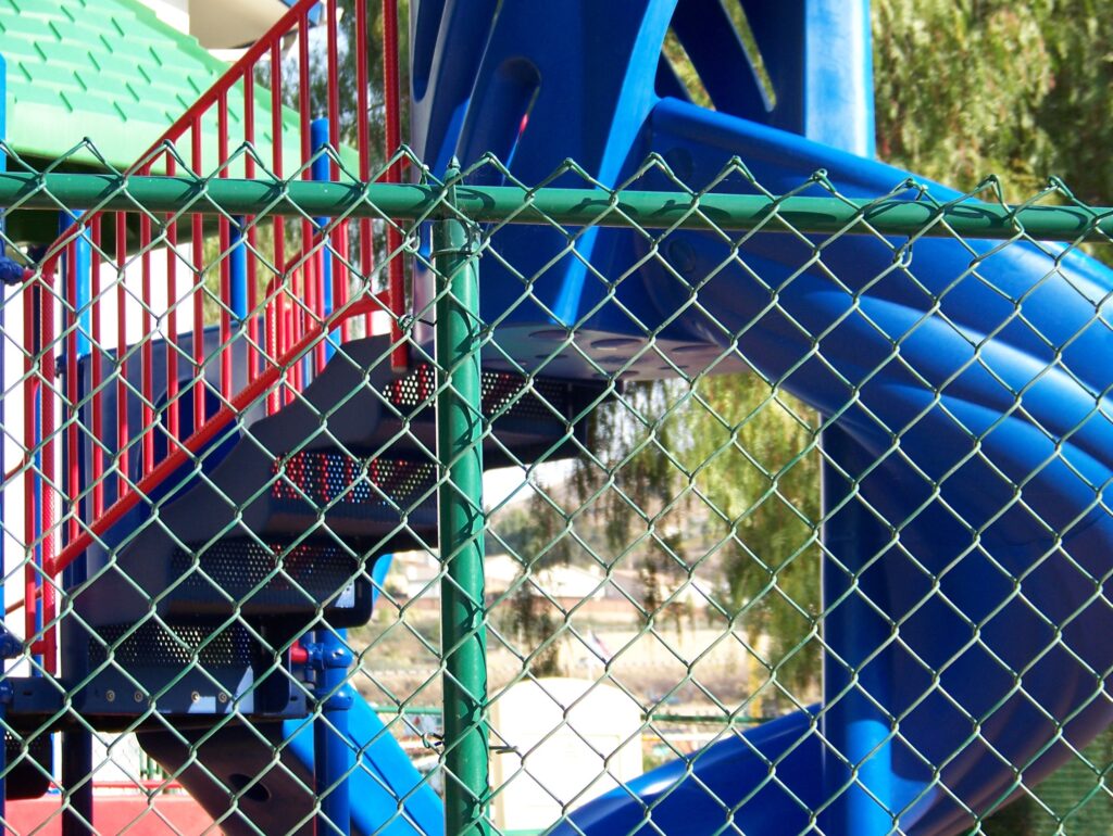 Green chain-link fence by Alpine Fence Company.