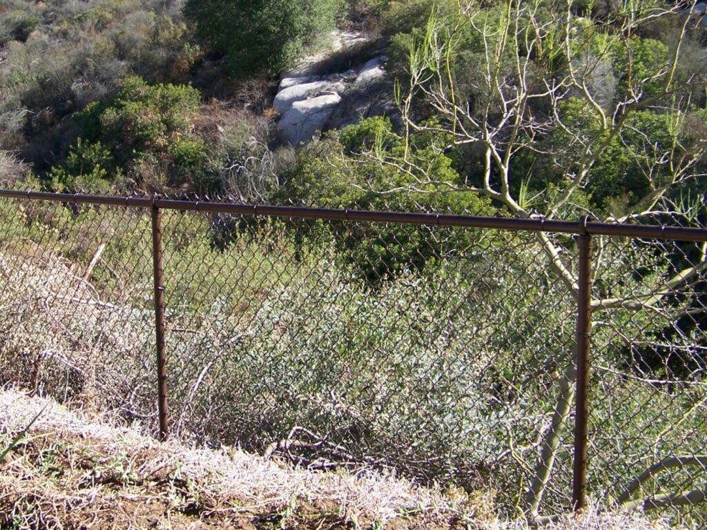 Brown chain-link fence by Alpine Fence Company.