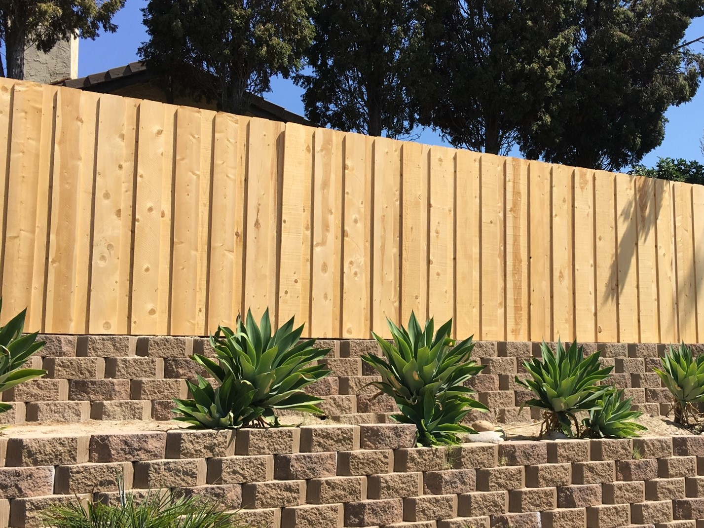 Dog-eared board-on-board wood fence by Alpine Fence Company.