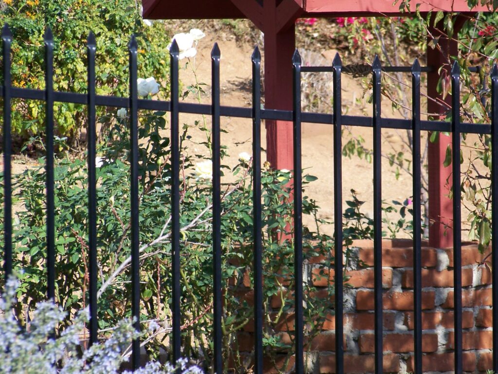 Pressed spear top iron fencing by Alpine Fence Company.
