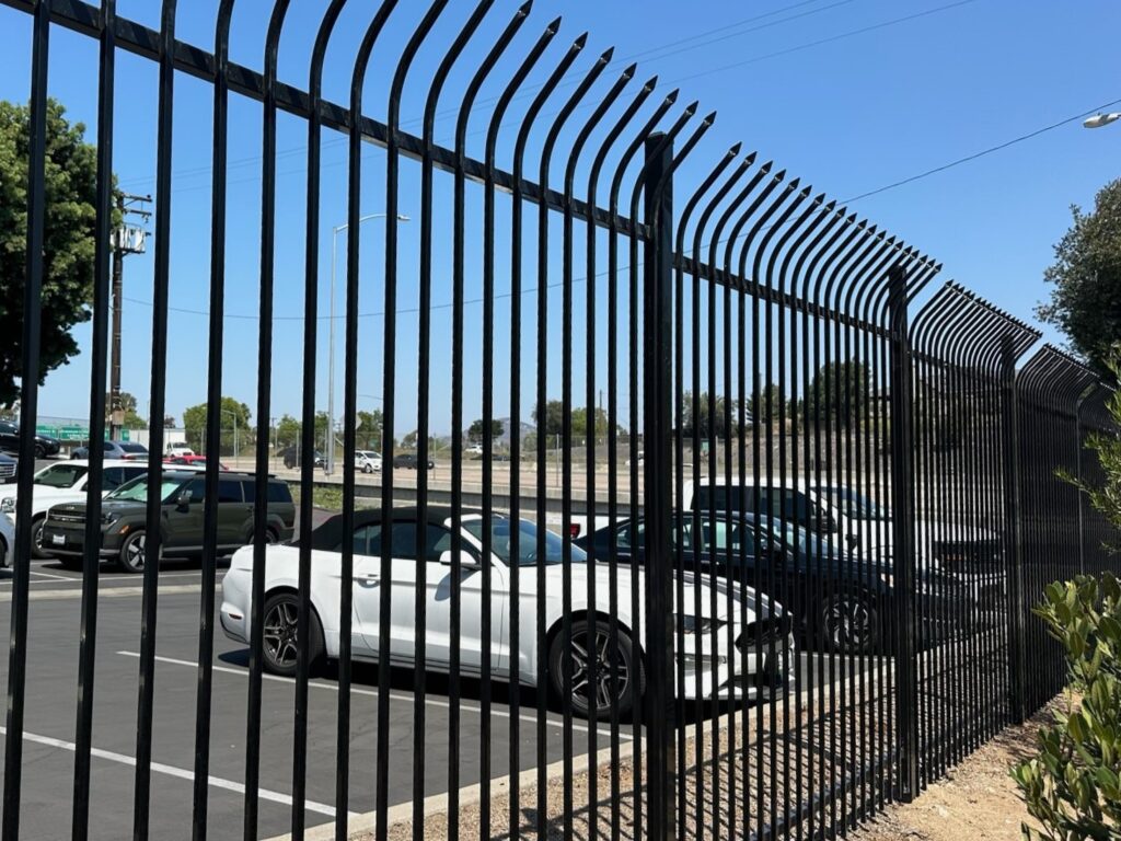 Curved top pressed spear iron fencing by Alpine Fence Company.
