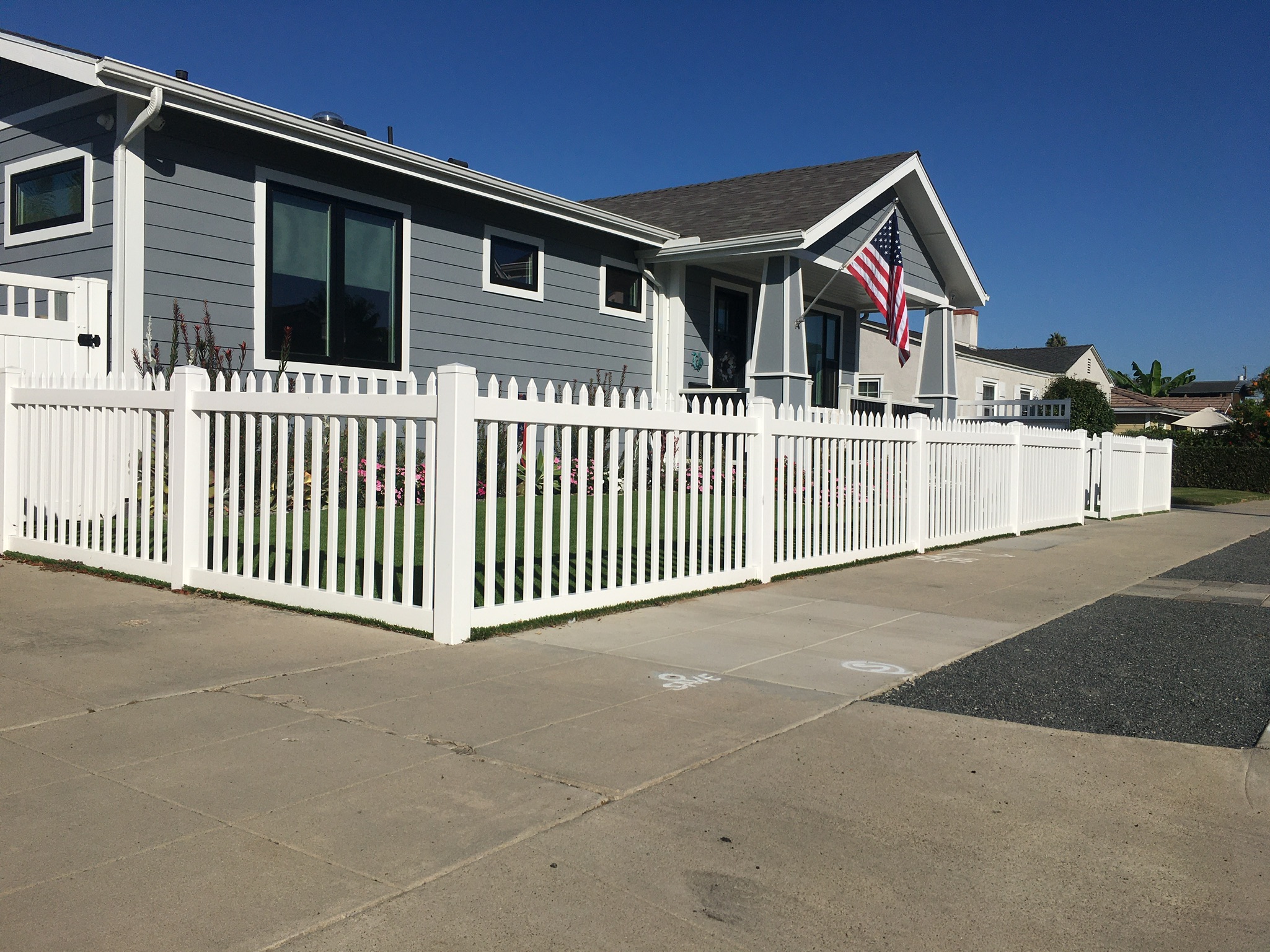 Narrow vinyl picket fence by Alpine Fence Company.