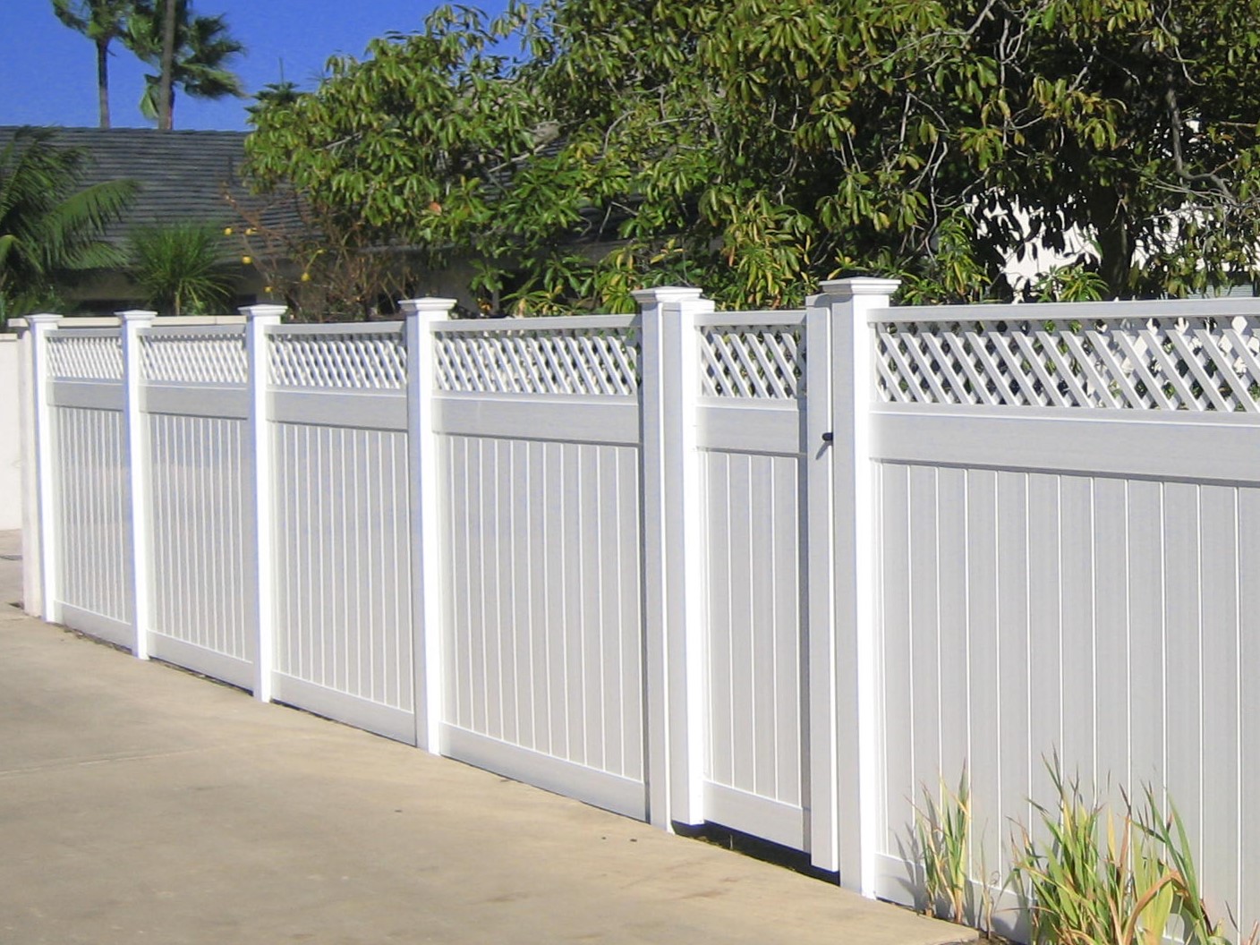 White lattice top vinyl fence by Alpine Fence Company.