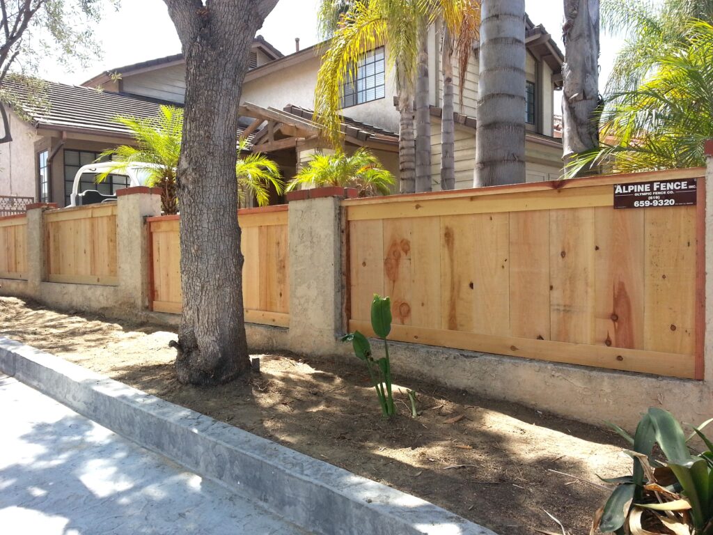 Cap and trim fence with mounted posts by Alpine Fence Company.