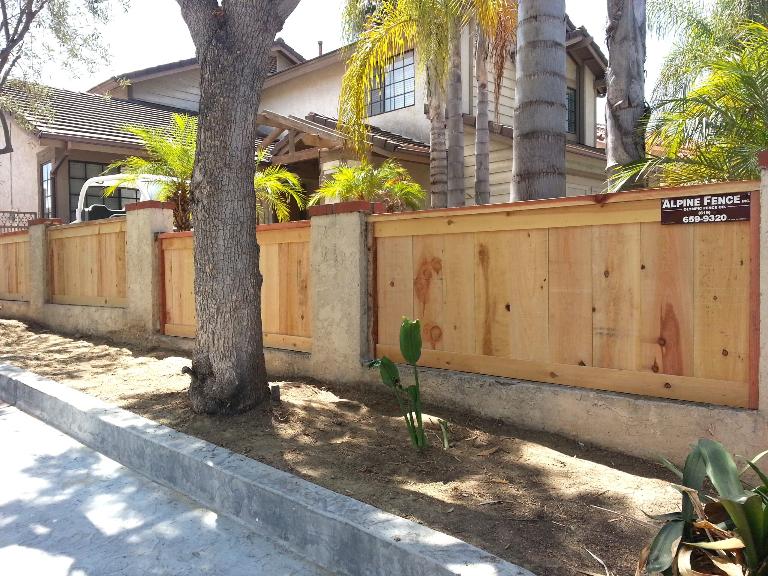 Cap and trim fence with mounted posts by Alpine Fence Company.