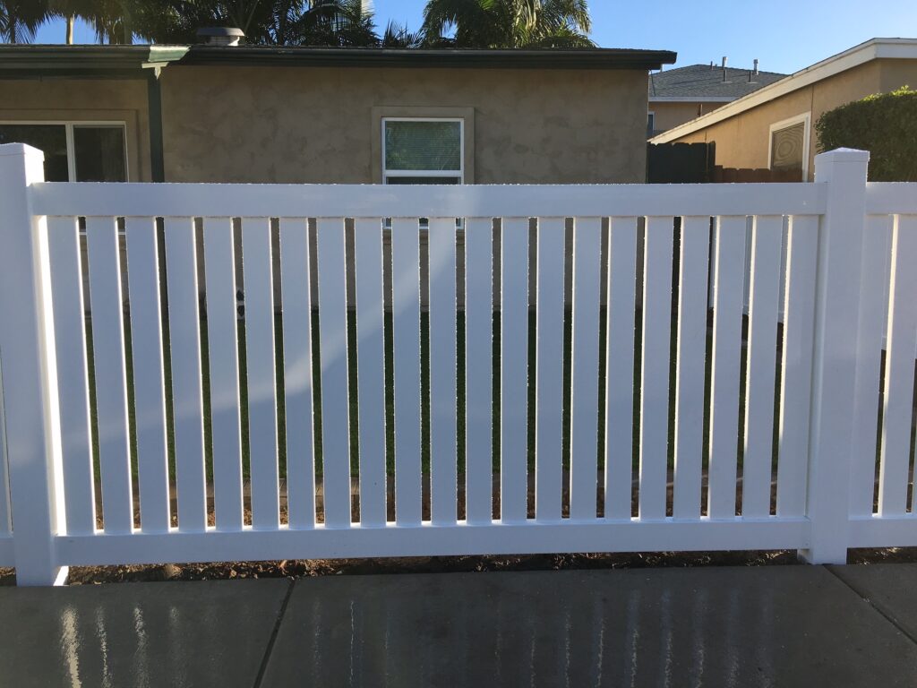 Universal vinyl fence with 1-inch space by Alpine Fence Company.