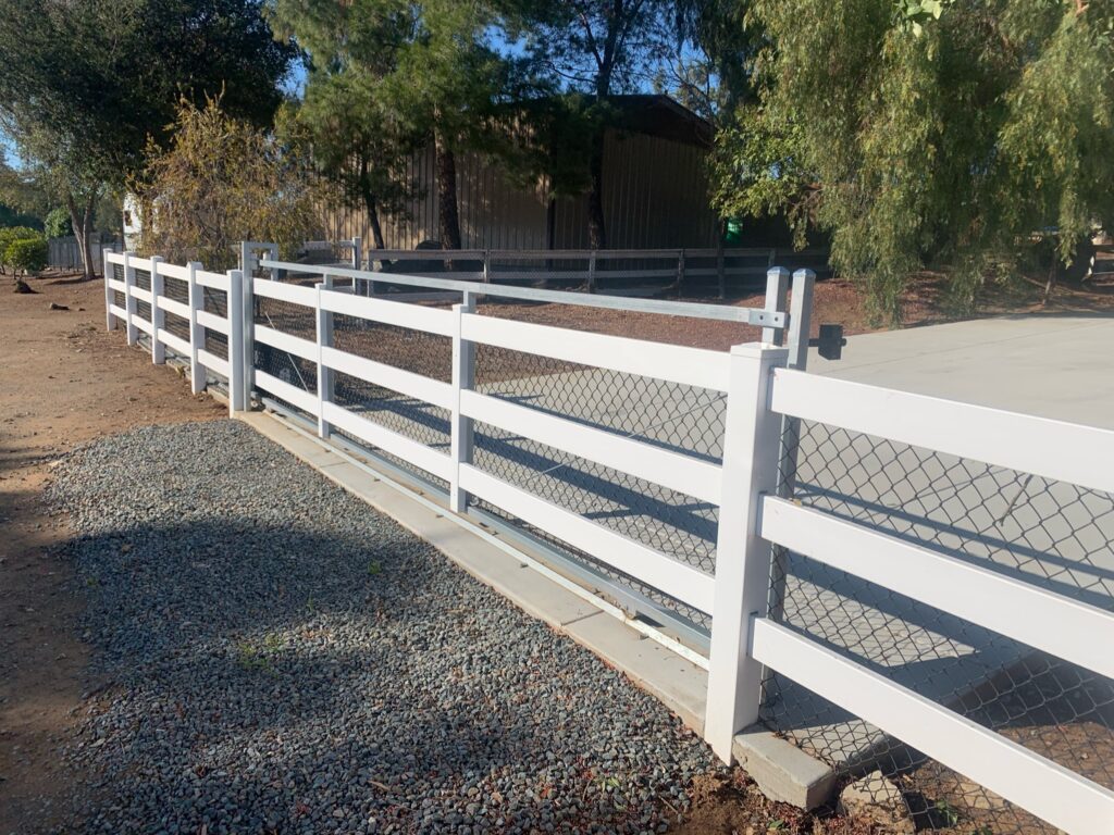 Vinyl ranch rail steel frame gate by Alpine Fence Company.