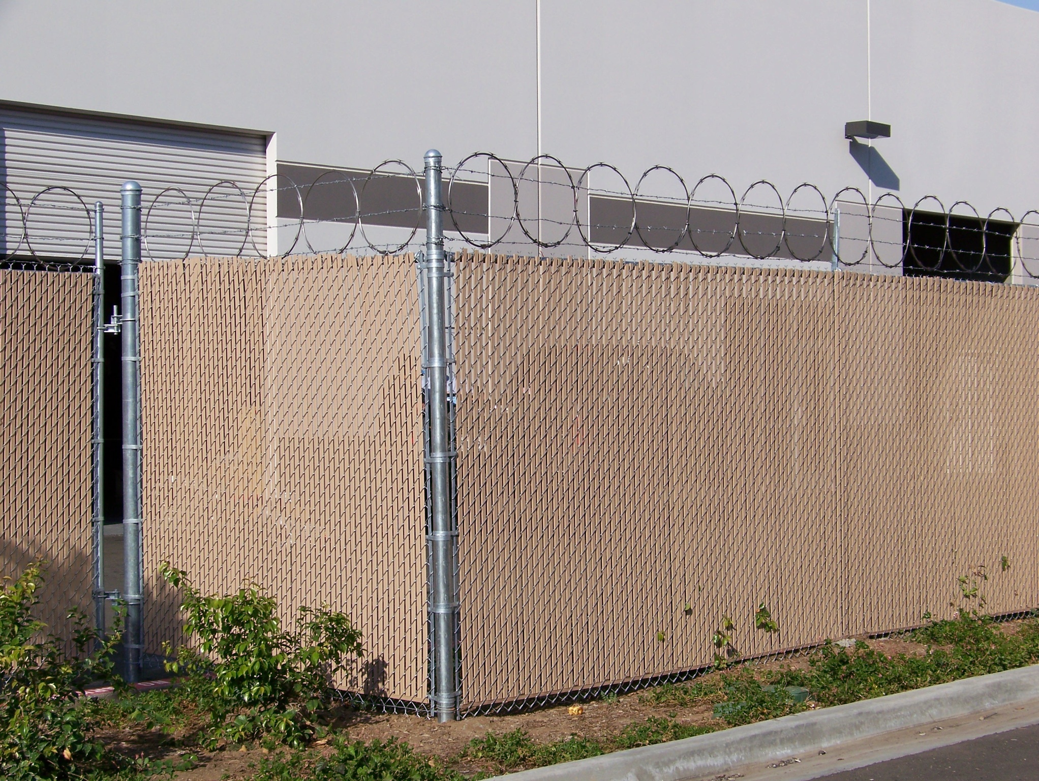 Commercial chain-link with slats by Alpine Fence Company.