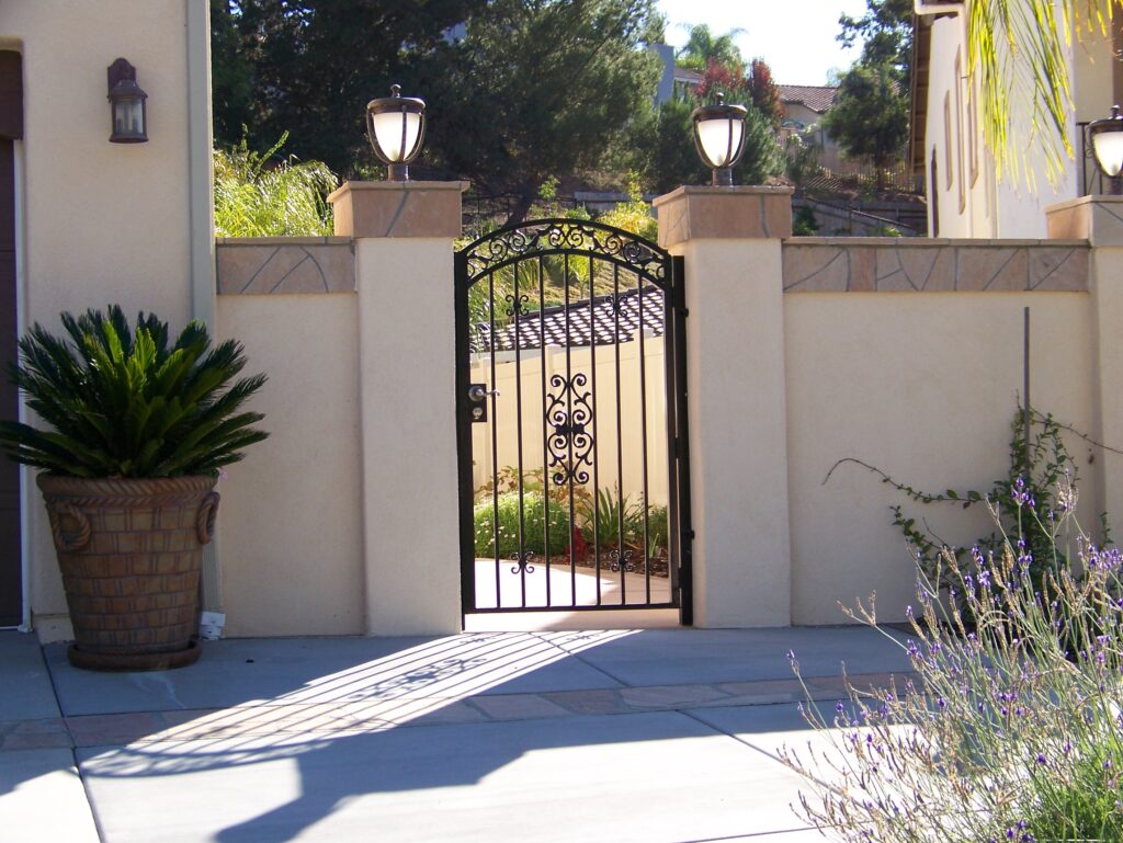 Custom ornamental iron entry gate by Alpine Fence Company.