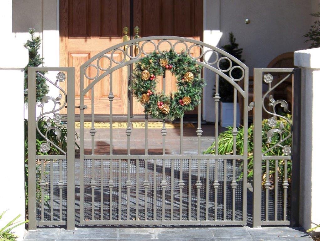 Custom iron entry gate by Alpine Fence Company.