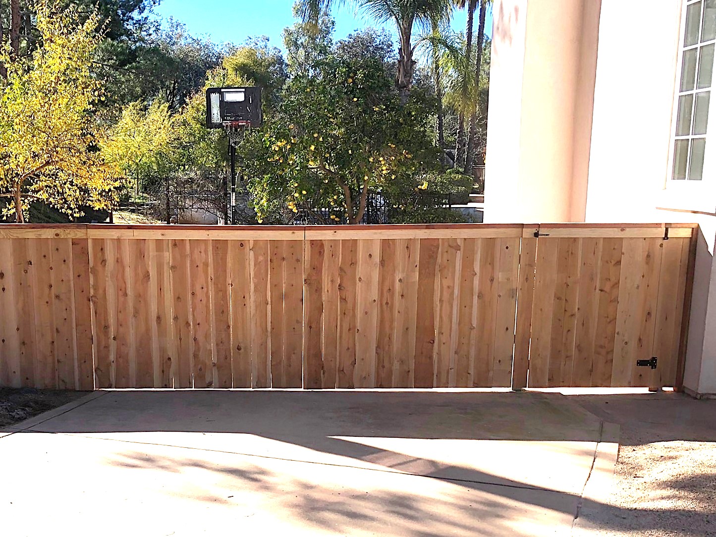 Outside view of a large steel-framed driveway gate by Alpine Fence.