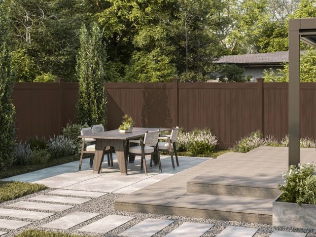 Dark walnut privacy vinyl fence by Alpine Fence Company.