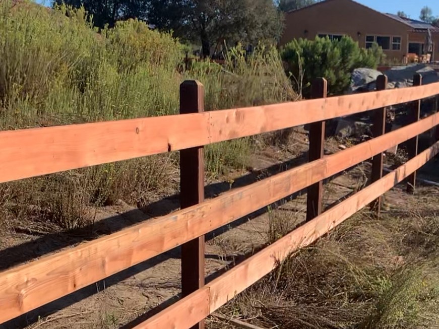 Wood ranch rail fence by Alpine Fence Company.