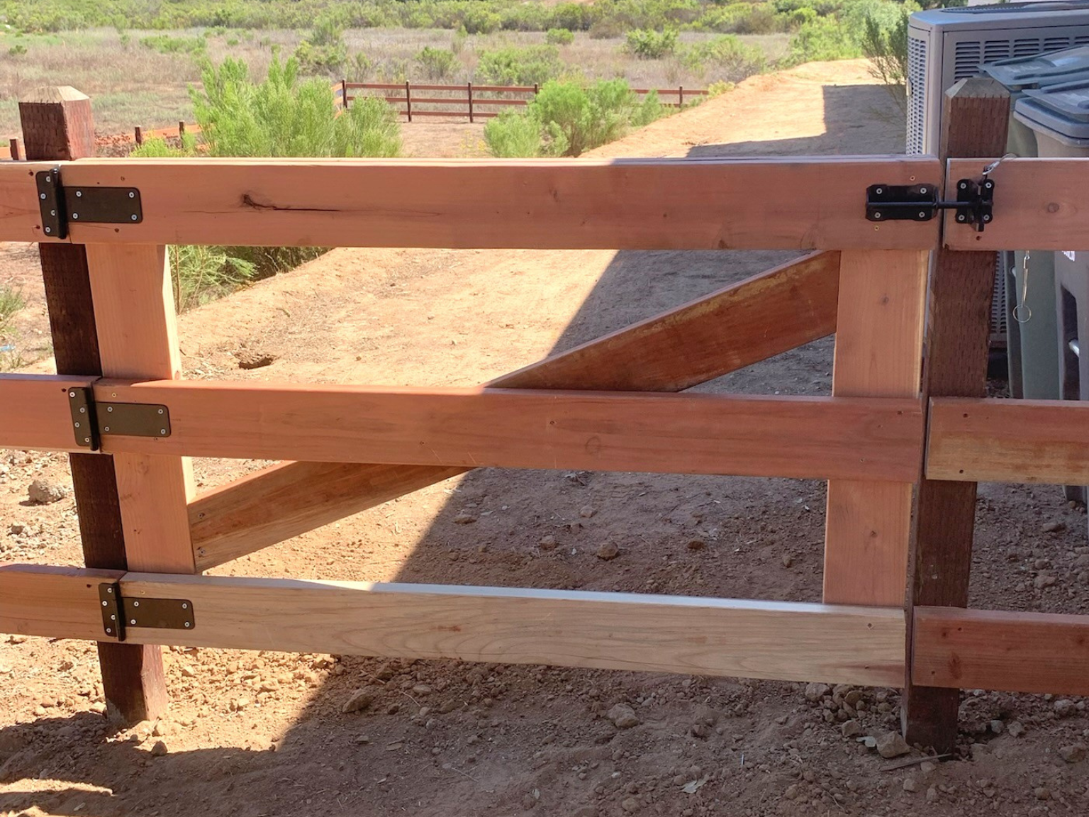 Wood ranch rail gate by Alpine Fence Company.