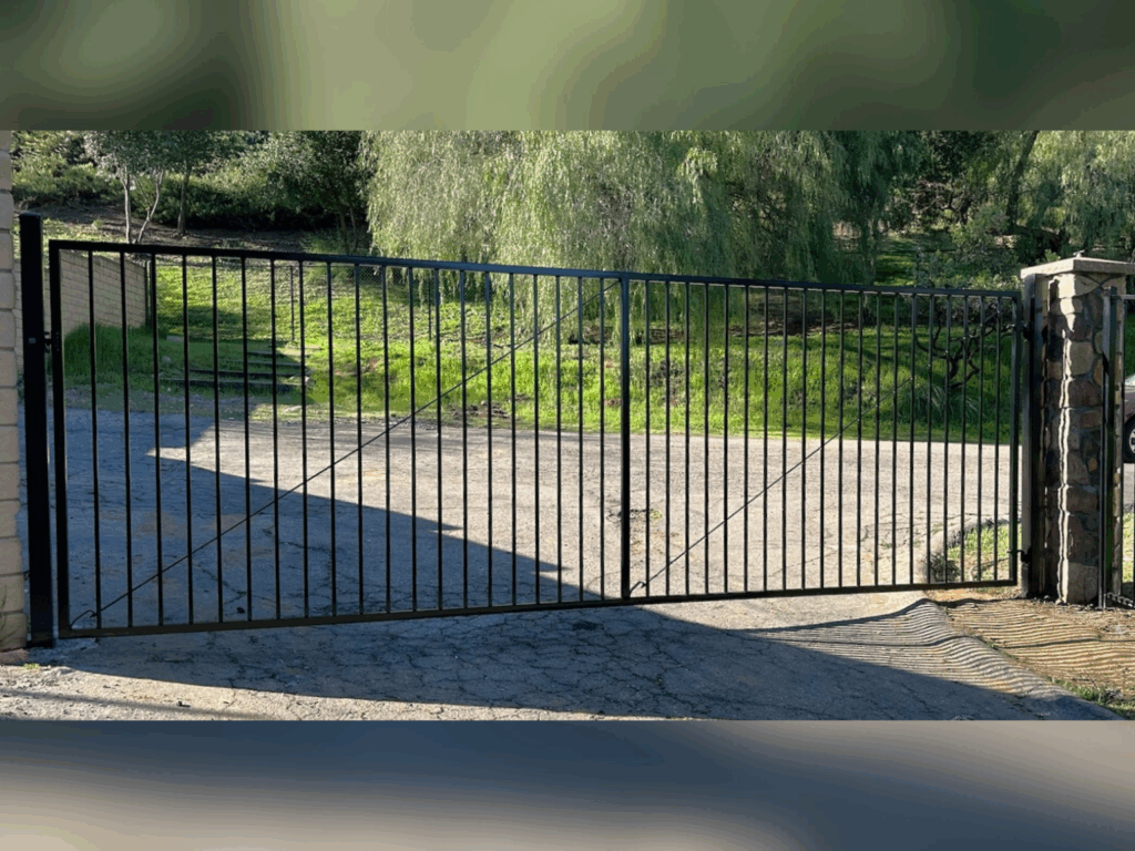 Ornamental iron standard driveway gate by Alpine Fence Company.