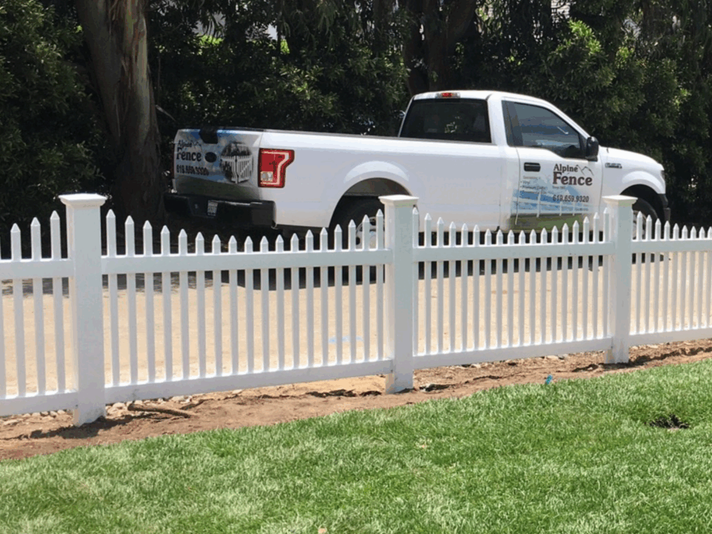 Scalloped narrow vinyl picket fence by Alpine Fence Company.