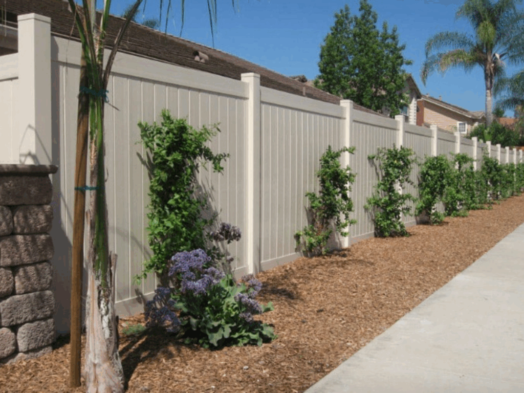 Tan vinyl privacy fence by Alpine Fence Company.