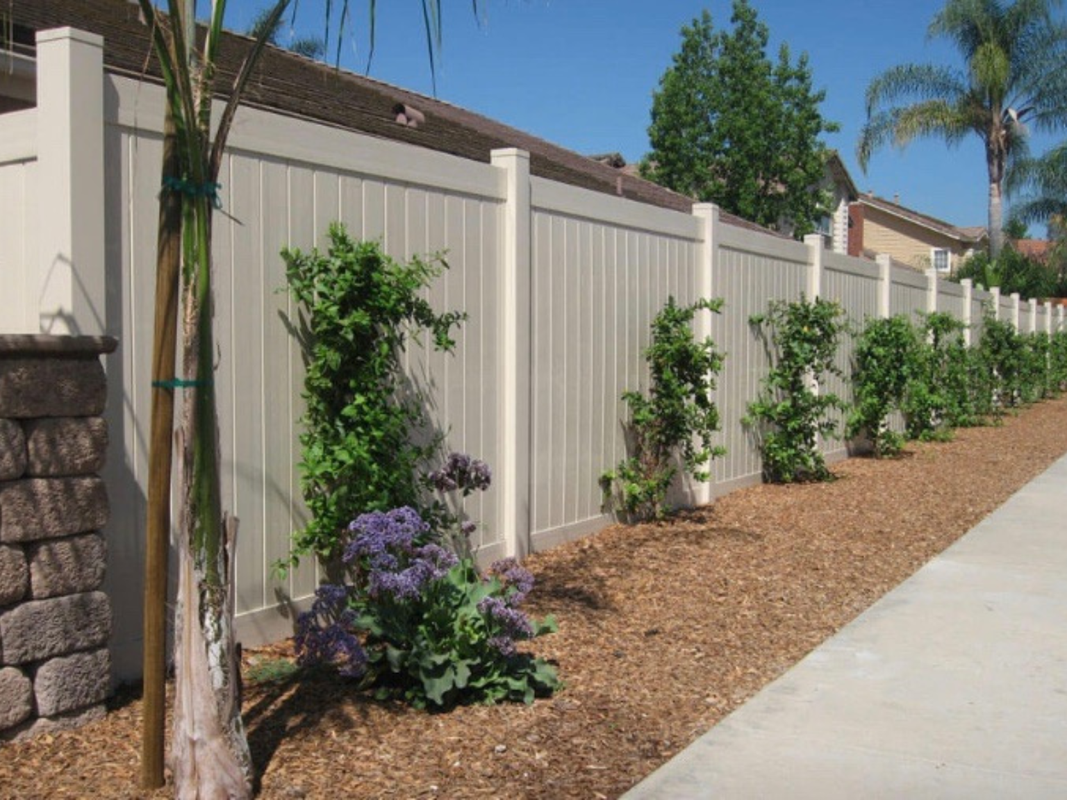 Tan vinyl privacy fence by Alpine Fence Company.