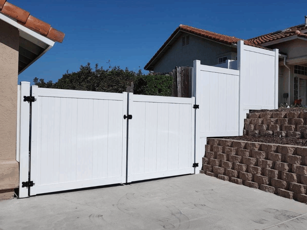 Large driveway vinyl privacy gates by Alpine Fence Company.