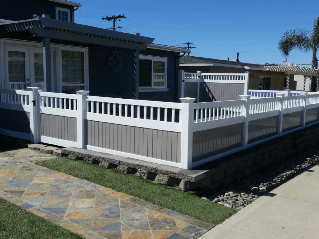 Two-tone vinyl fence with universal top by Alpine Fence Company.