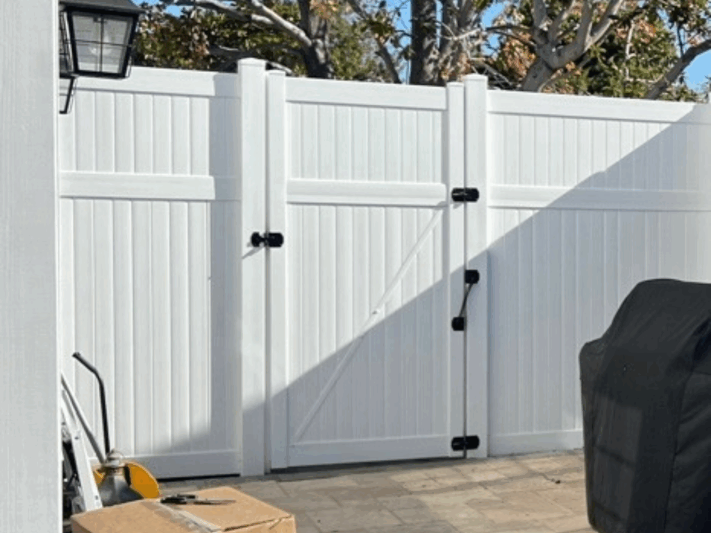 8' tall white privacy vinyl fence and gate by Alpine Fence Company.