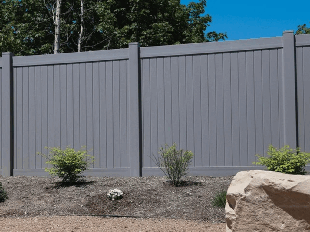 Gray vinyl privacy fence by Alpine Fence Company.