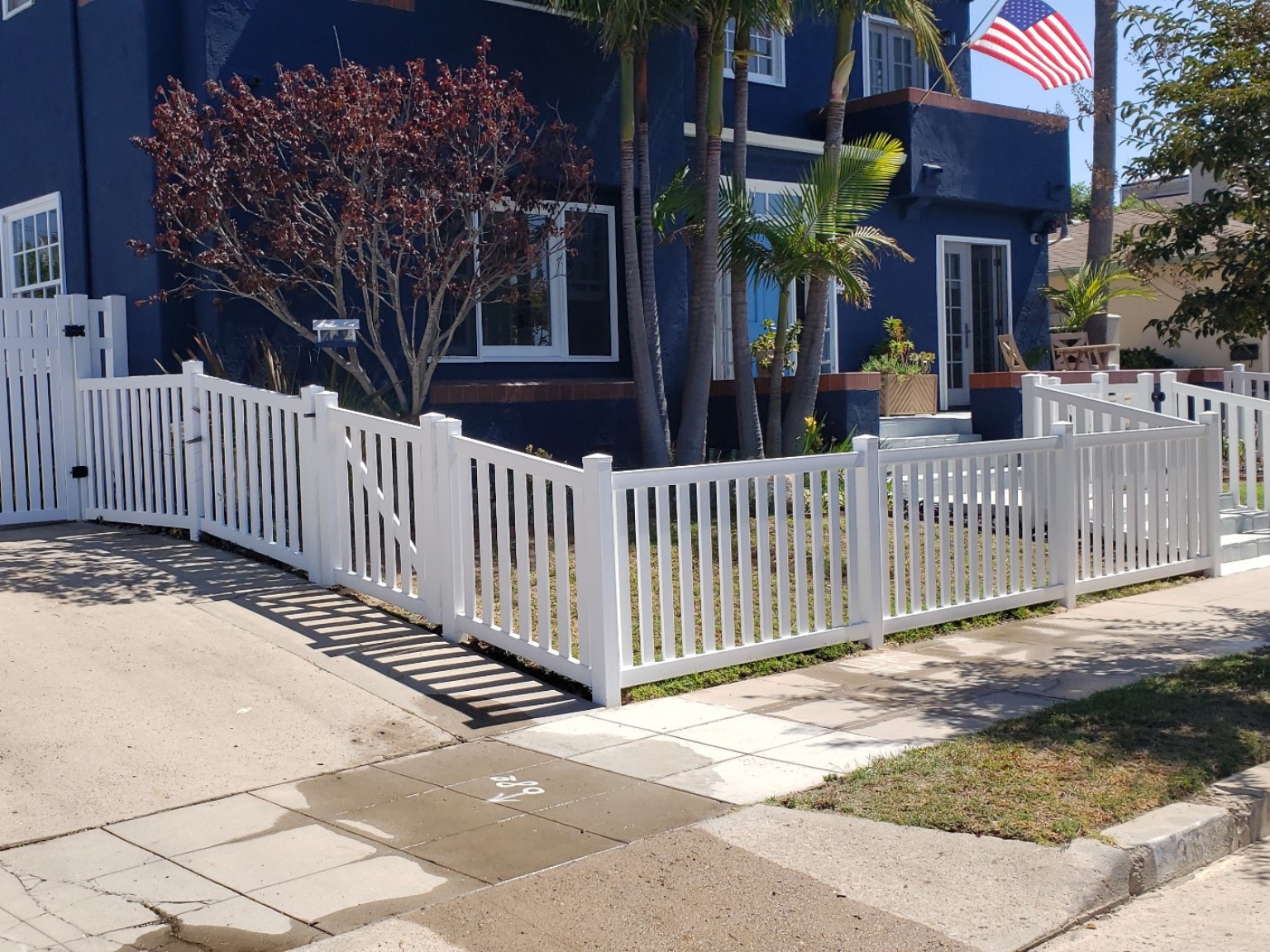 Universal vinyl fence with 2-inch space by Alpine Fence Company.