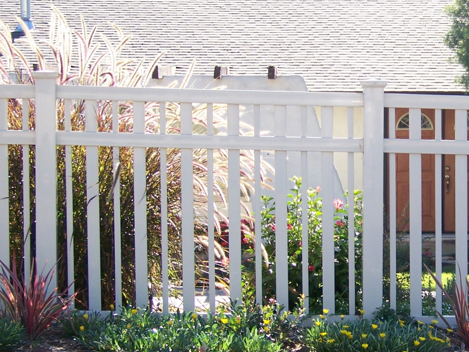 Decorative universal vinyl fence by Alpine Fence Company.