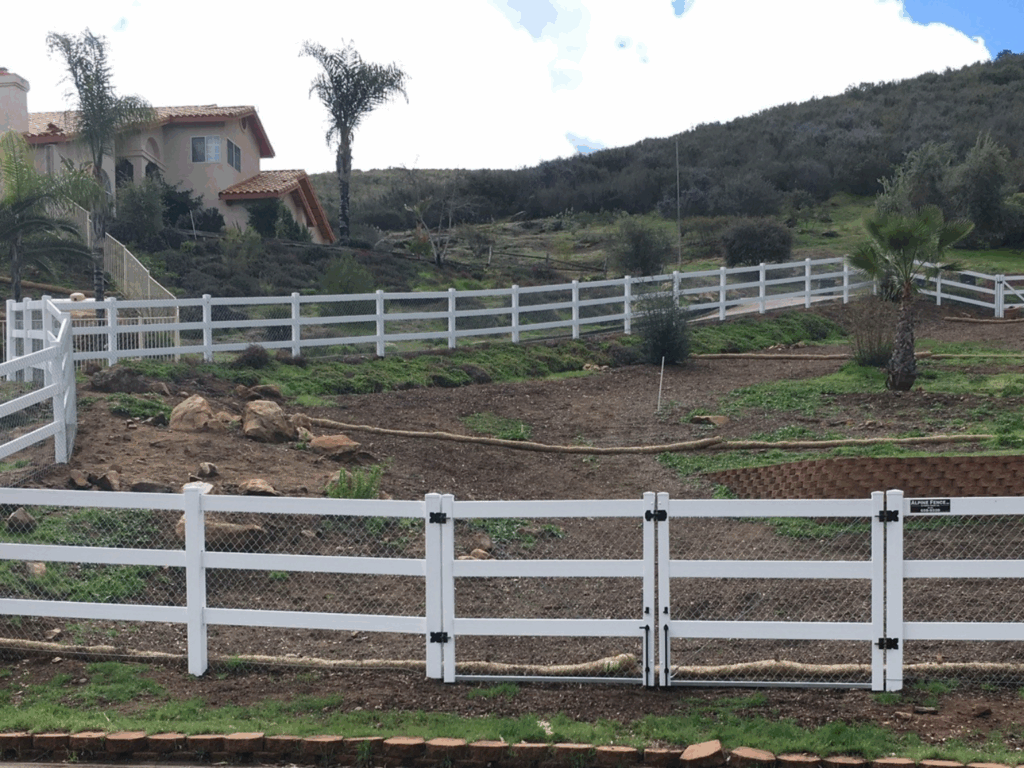 All terrain vinyl ranch rail by Alpine Fence Company
