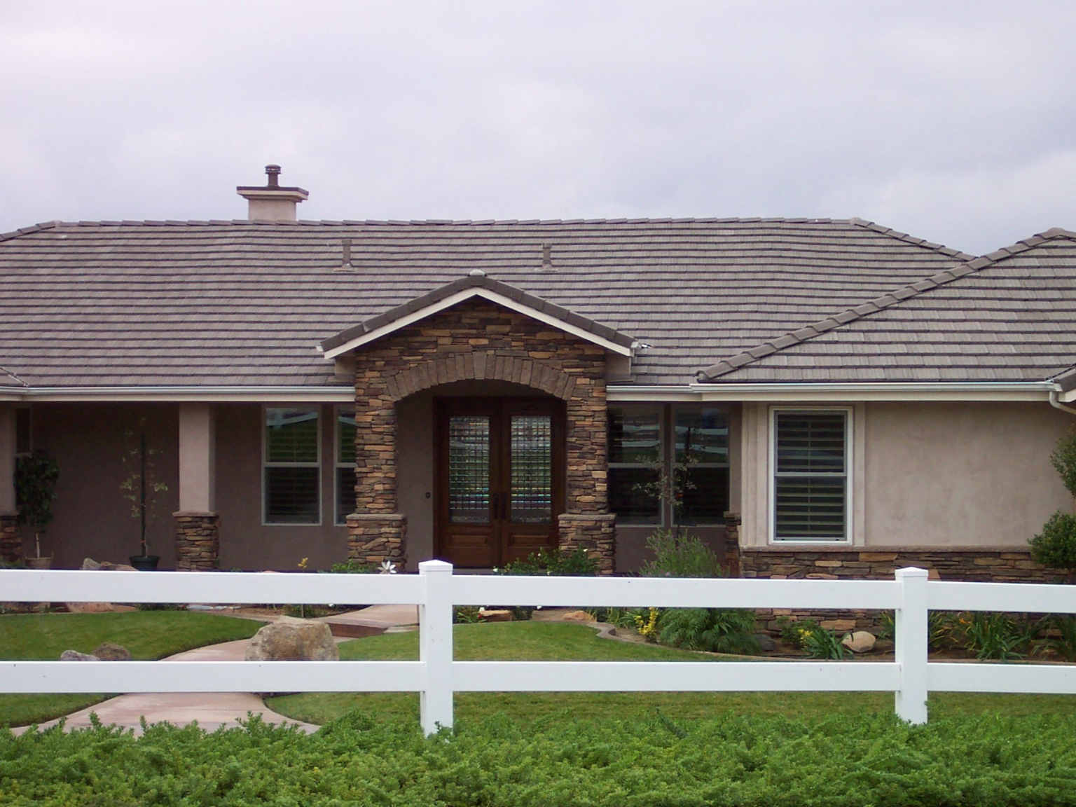 White vinyl ranch rail by Alpine Fence Company.