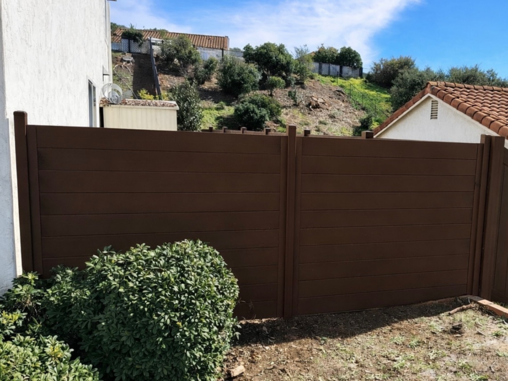 3. Custom metal privacy fence painted dark brown to provide seclusion, security, and aesthetics.
