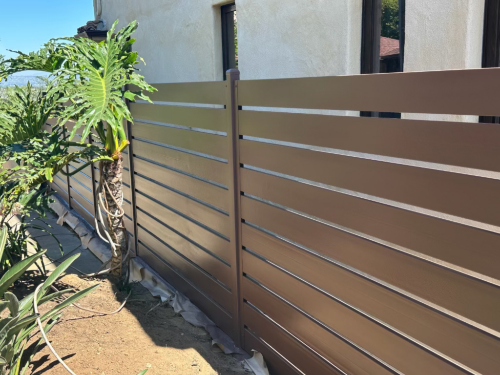 4. Semi-privacy metal fence with custom brown slats.