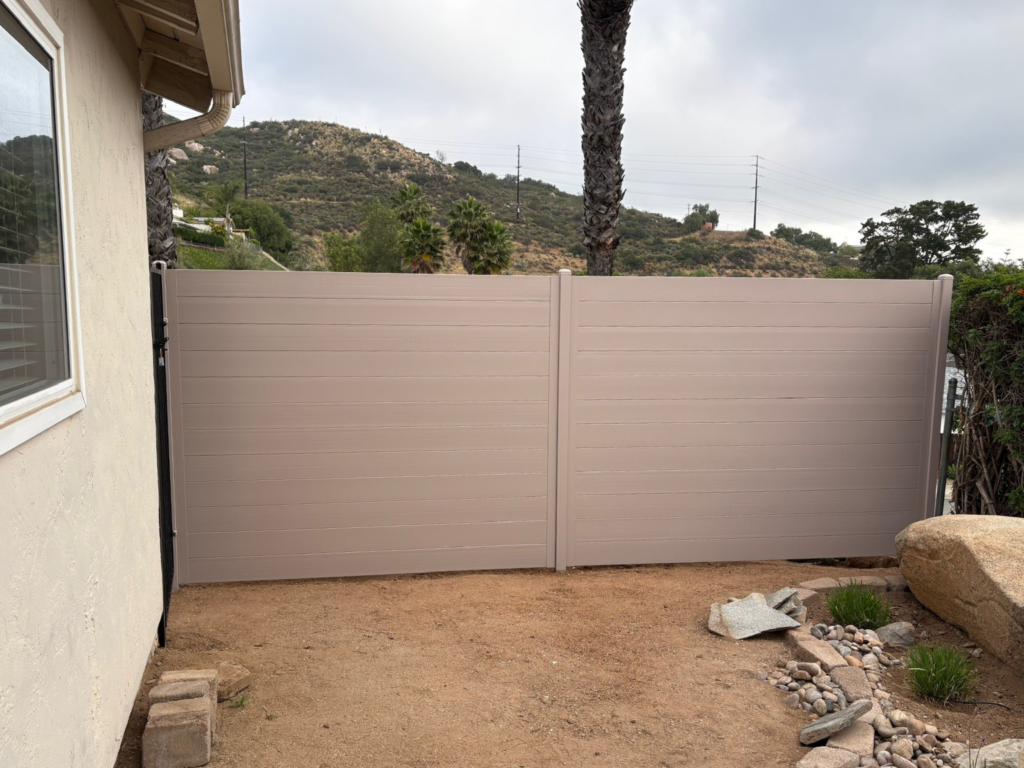 10. Tan metal privacy fencing on the side of a residential property in San Diego County.