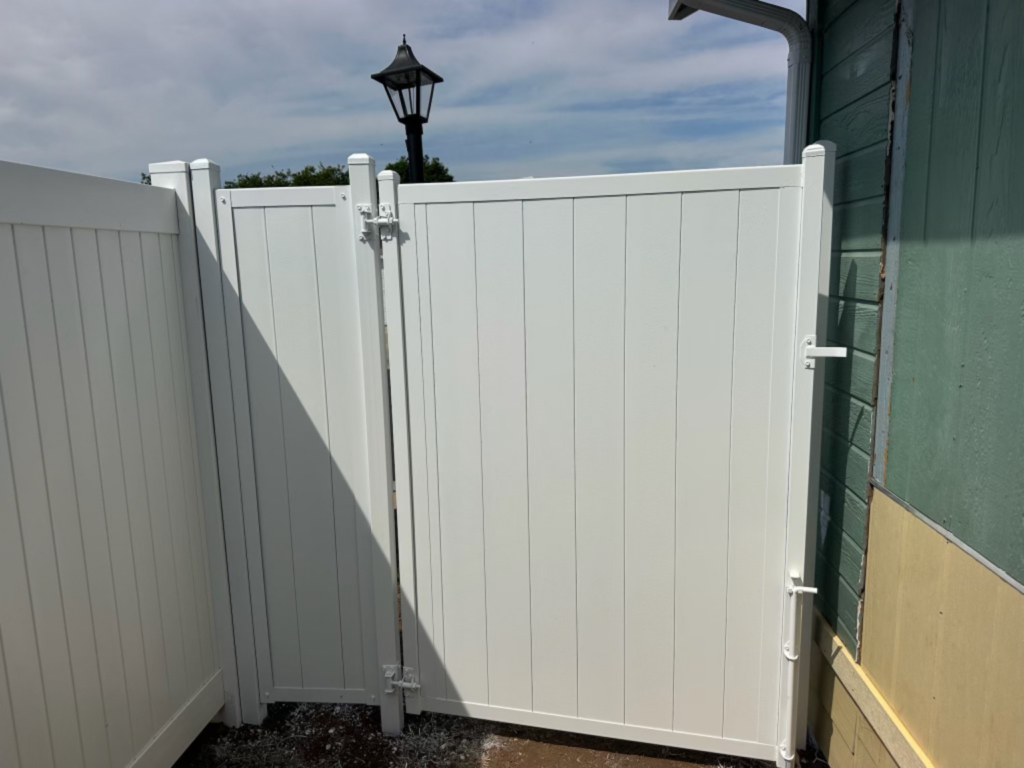 1. Full privacy metal fence with gate by Alpine Fence Company.