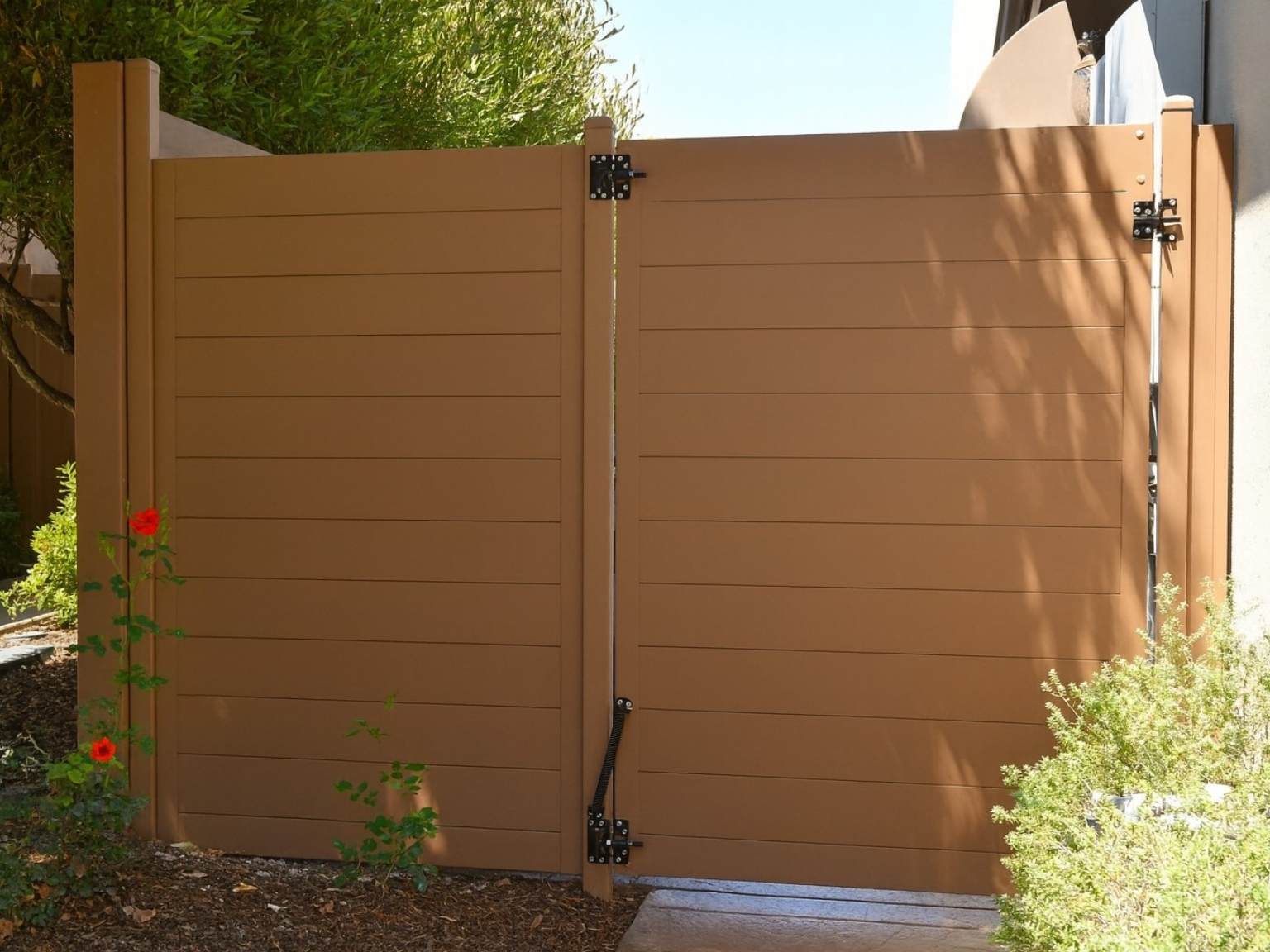 13. Horizontal metal privacy fence with gate.